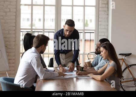 Young middle eastern ethnicity boss and diverse staff during briefing Stock Photo