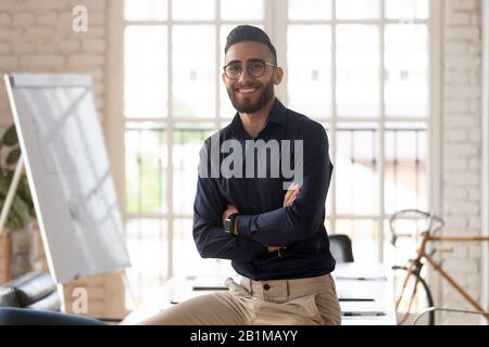 Successful arab businessman arms crossed looking at camera smiling Stock Photo