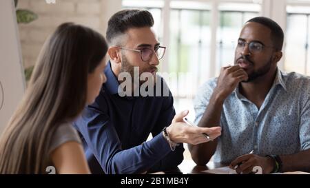 Group meeting led by middle eastern ethnicity team leader Stock Photo