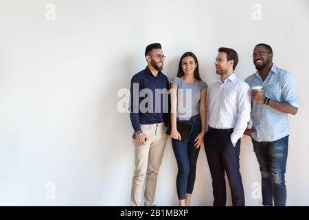 Millennial generation arab african european businesspeople posing isolated on grey Stock Photo