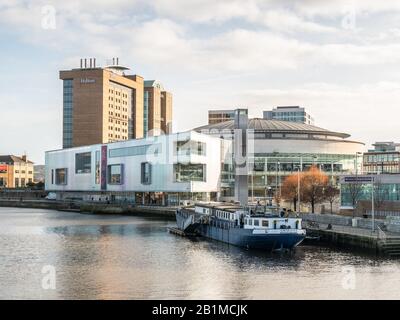 Belfast, Northern Ireland, UK - February 23, 2020: Confiance, the Belfast Barge with Waterfront Hall and Hilton Hotel in the background Stock Photo