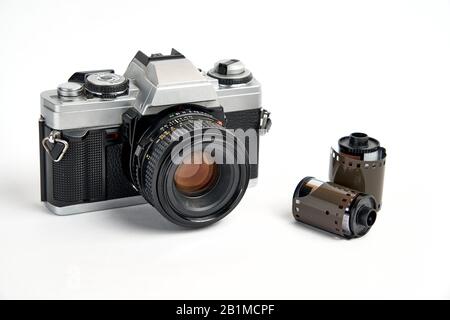 Classic analog 35 mm camera vintage and analog film rolls on white background Stock Photo