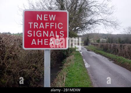 February 2020 - Country lane with a road sign for new traffic signals  ahead. For the rural cable laying route from Hinkley Point Stock Photo
