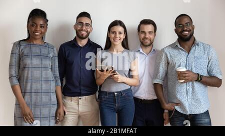 Happy diverse business people or students standing looking at camera Stock Photo