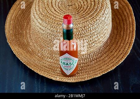 bottle of Tabasco sauce, spicy chilis, bright colors, red, blue Stock Photo