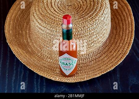 bottle of Tabasco sauce, spicy chilis, bright colors, red, blue Stock Photo