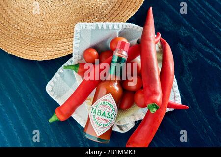 bottle of Tabasco sauce, spicy chilis, bright colors, red, blue Stock Photo