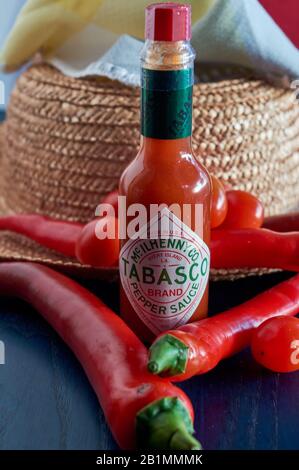 bottle of Tabasco sauce, spicy chilis, bright colors, red, blue Stock Photo