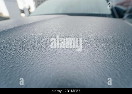 Raindrops on the hood of the car. Close-up. Stock Photo