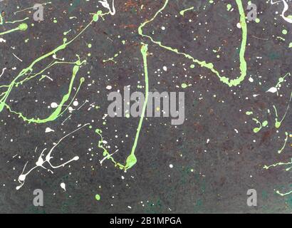 Splashes of colored paint on a black surface. Stock Photo