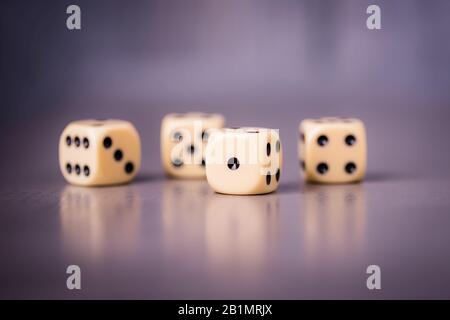 Four dices on a gray violet background, copy space Stock Photo