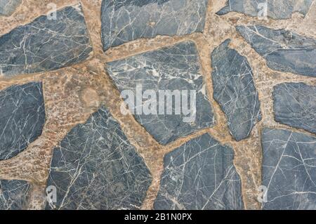 Pavement texture with fragments of natural gray stone. Stock Photo