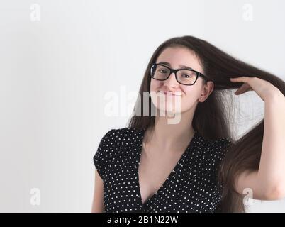 Portrait of a Bespectacled Long-haired Brunette Teen Girl Stock Photo