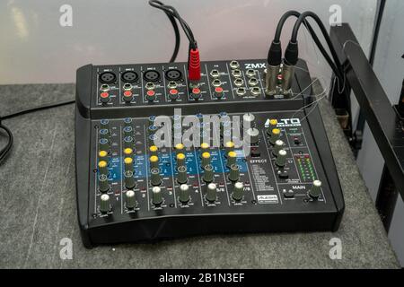 A DJ's mixing board or mixing deck with cables Stock Photo