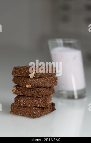 Keto chocolate brownies cakes slices with a glass of milk. Front view. Stock Photo