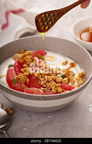 Yougurt bowl with grapefruit slices and granola Stock Photo