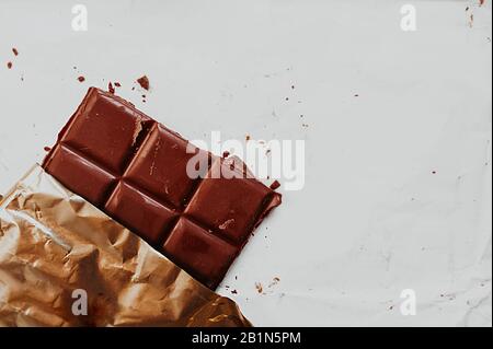 Chocolate bar in gold foil Stock Photo - Alamy