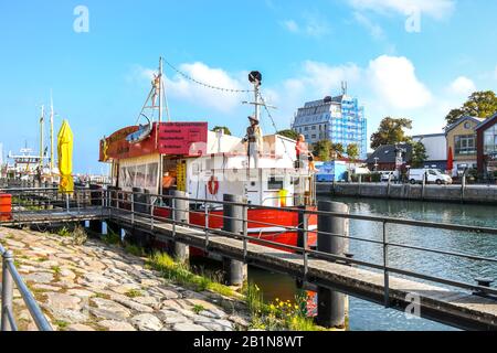 Two pirate figures rest on the deck of a tourist boat in the Alter Strom Canal in the Baltic Sea port city of Warnemunde, Germany. Stock Photo