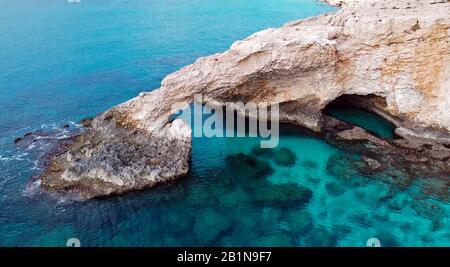 stone bridge for lovers Love Bridges on the seashore near mountains on Ayia Napa island Cyprus Stock Photo