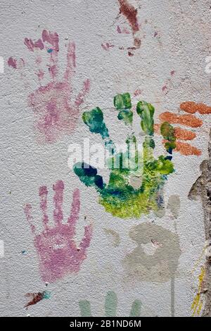 Colorful handprints on a wall. Stock Photo