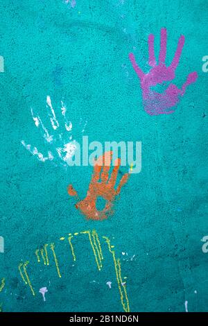 Colorful handprints on a wall. Stock Photo