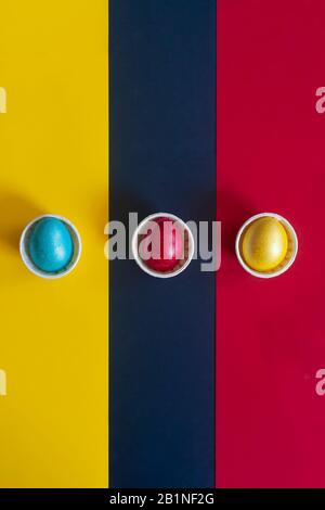 Minimalistic easter background. Colorful easter eggs on the multicolored background. View from above. Top view. Flat lay image Stock Photo
