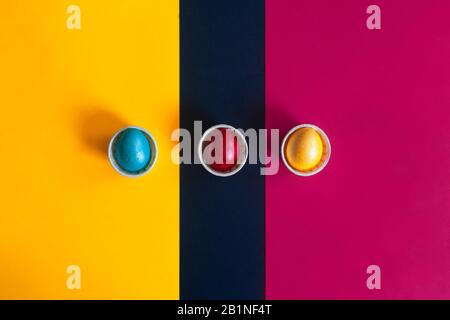 Minimalistic easter background. Colorful easter eggs on the multicolored background. View from above. Top view. Flat lay image Stock Photo