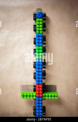 Toy train made with plastic bricks. Top view. Vertical image. Copy space. Plastic brick toys for baby. Top view. Stock Photo