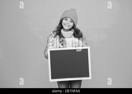 Happy hours. Promotion concept. Smiling girl wear winter outfit show blank chalkboard copy space. Fresh information. Schedule and working hours. Open hours. Winter entertainment and activities. Stock Photo