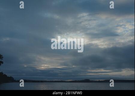 sea dark landscape of heavy gray clouds before a storm in bad weather Stock Photo