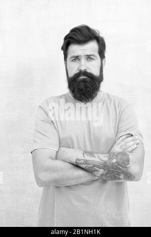 Bearded hipster brutal guy. Products is essential for maintaining men beard care. Grow long beard. Challenges like dryness ingrown hairs and irritation. Find best beard design shape for facial hair. Stock Photo