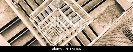 A computer-sized banner of aerial view of staircase spiraling downward. Stock Photo