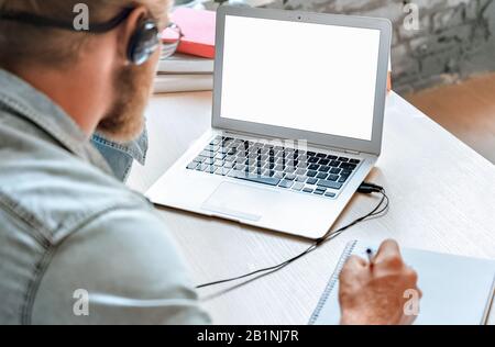 Close up student use laptop make notes watching webinar mock up screen. Stock Photo