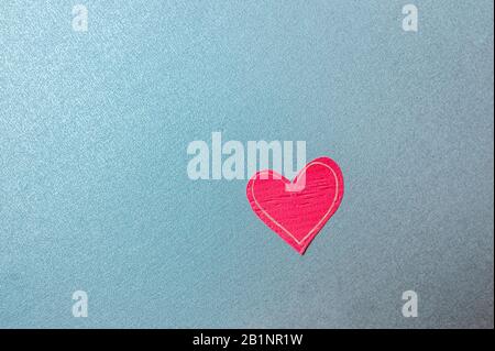 bright red eco-friendly heart made of paper on a uniform blue background, minimalist empty card for a loved one about love and feelings Stock Photo