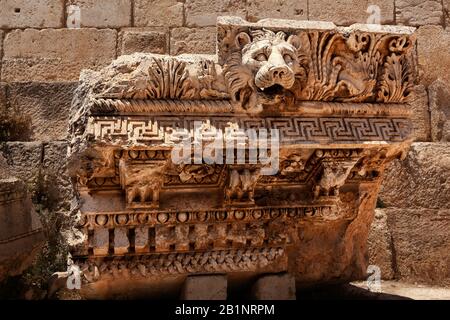 Fallen capital with lion head that was an aqueduct spout at the Temple of Jupiter, UNESCO World Heritage Site, Baalbek, Lebanon. Stock Photo