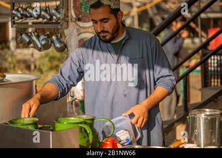 Islamabad, Islamabad Capital Territory, Pakistan - February 5, 2020, A man making tea at a tea stall in a winter morning. Stock Photo
