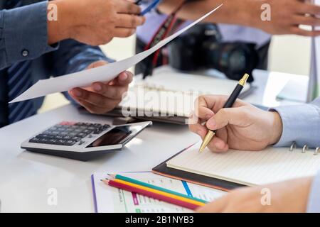 Magazine photographers meeting before working on models in studio. Stock Photo