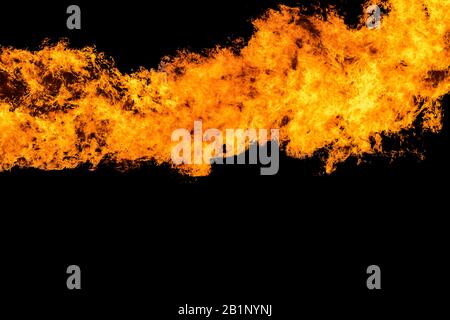 Flames caused by the explosion of the oil isolated on black background. Demonstration of water on oil fire. Stock Photo