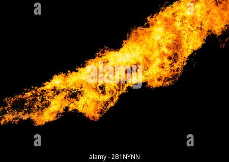 Flames caused by the explosion of the oil isolated on black background. Demonstration of water on oil fire. Stock Photo