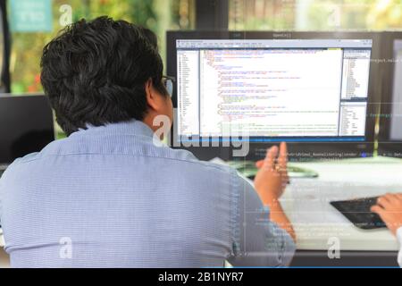 Programmer working in a software developing. Developing programming and coding technologies. Website design. Cyber space concept. Stock Photo
