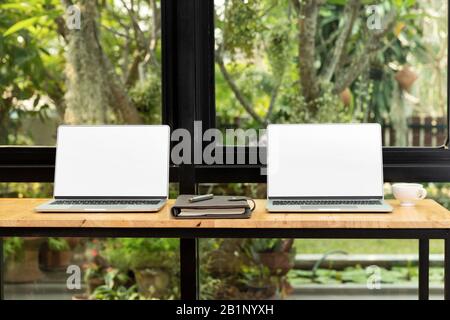 Laptop with blank screen on table. Workspace desk and laptop. copy space and blank screen. Business image, Blank screen laptop and supplies. Stock Photo