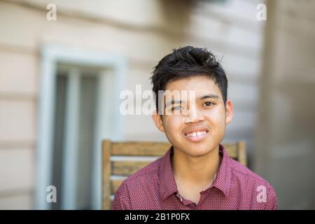 Young mixed race teenage boy looking at the camera