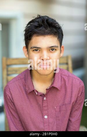 Young mixed race teenage boy looking at the camera