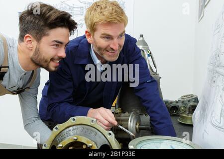 engineers looking at plans and future project with excitement Stock Photo