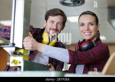 engineer training female apprentice on milling machine Stock Photo