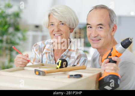 happy senior couple doing diy Stock Photo