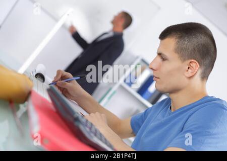 male student attending adult education class Stock Photo