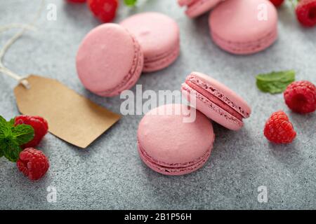 Raspberry macarons on gray table Stock Photo