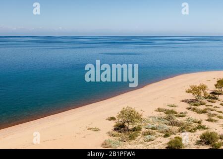 Lake Issyk-kul, Kyrgyzstan, empty sandy beach on the southern shore of the lake Stock Photo