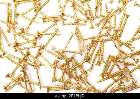 Background from yellow zinc screws. Torx screw on white background Stock Photo